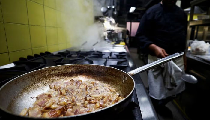 A cook prepares pasta Carbonara at La Carbonara restaurant in Campo de Fiori in Rome, Italy, December 14, 2023.—Reuters