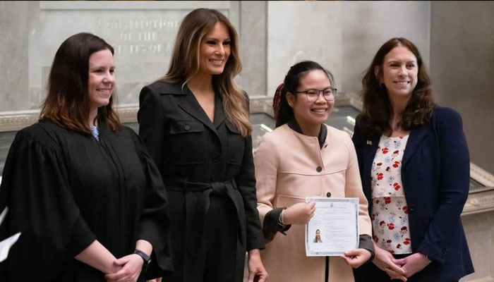 Melania Trump is seen alongside Judge Elizabeth Gunn, left, and US Archivist Colleen Shogan, far right, as they pose for photographs with a newly sworn-in citizen at the National Archives in Washington, DC, on December 15, 2023. —AFP