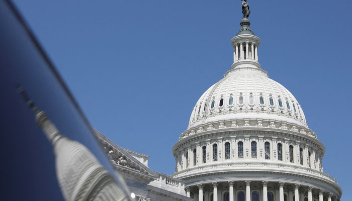 The dome of the US Capitol is reflected in a window on Capitol Hill in Washington, US, April 20, 2023. —Reuters