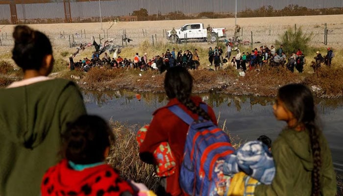 Migrants seeking asylum in the United States gather on the banks of the Rio Bravo river, as the Texas National Guard blocks the crossing at the border between the United States and Mexico, as seen from Ciudad Juarez, Mexico December 5, 2023. — Reuters