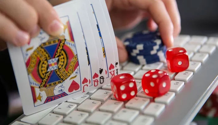 Keyboard, cards, chips and dice are seen in this image on June 5, 2020. — Reuters