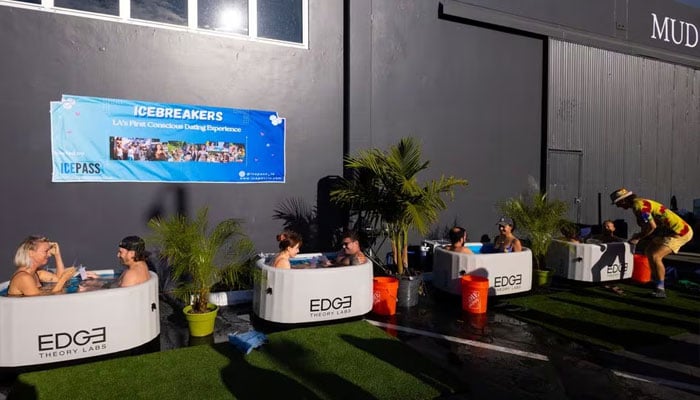 People sit in baths of cold water to help break the ice while speed dating, in Santa Monica, California, US, December 16, 2023.—Reuters