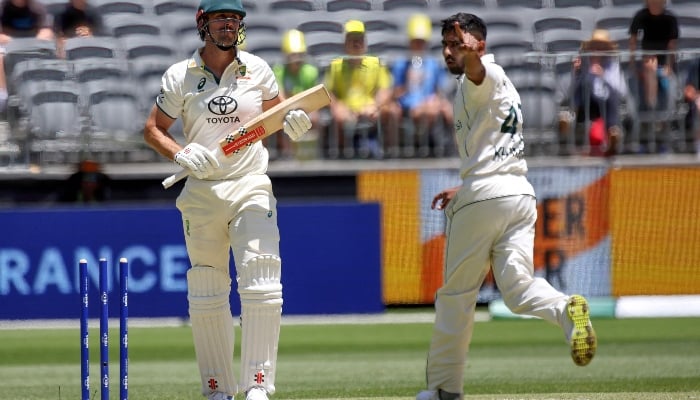 Mitchell Marsh (Kiri) dari Australia terpesona oleh Khurram Shahzad (kanan) dari Pakistan pada hari kedua pertandingan Tes kriket pertama antara Australia dan Pakistan di Perth pada 15 Desember 2023.—AFP