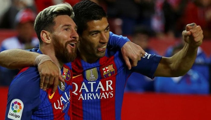 Barcelonas Luis Suarez celebrates with Lionel Messi after scoring. —Reuters