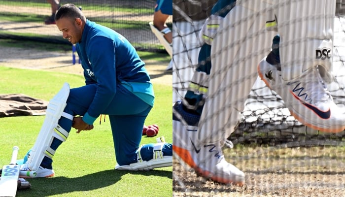 Australian batsman Usman Khawaja prepares to bat in the nets during a practice session at the Melbourne Cricket Ground (MCG) in Melbourne on December 24, 2023, ahead of the second cricket Test match against Pakistan. His shoes displaying a dove symbol is visible on the image at the right. — AFP