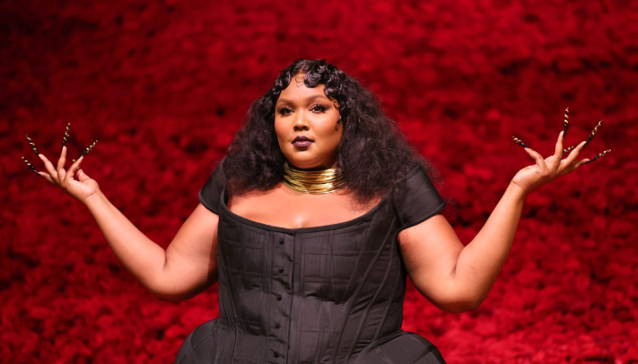 Lizzo Gets in the Christmas Spirit With Reindeer Antlers and a Sparkly  Cropped Sweater - Fashionista