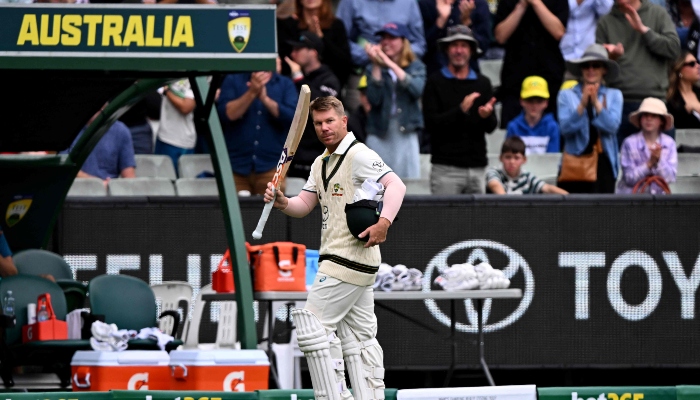 Australian batsman David Warner waves to the fans after being dismissed on the third day of the second cricket Test match between Australia and Pakistan at the Melbourne Cricket Ground (MCG) on December 28, 2023. —AFP