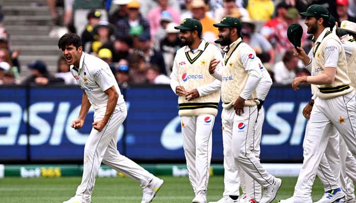 Pakistan bowler Mir Hamza (left) celebrates with teammates after dismissing Australian batsman Travis Head on the third day of the second cricket Test match between Australia and Pakistan at the Melbourne Cricket Ground (MCG) in Melbourne on December 28, 2023. — AFP