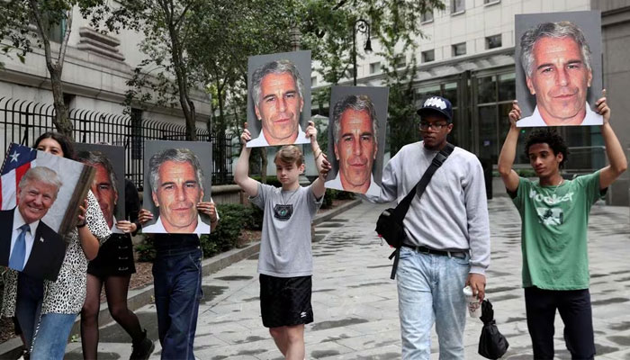 Demonstrators hold signs aloft protesting Jeffrey Epstein, as he awaits arraignment in the Southern District of New York on charges of sex trafficking of minors and conspiracy to commit sex trafficking of minors, in New York, US, July 8, 2019. — Reuters