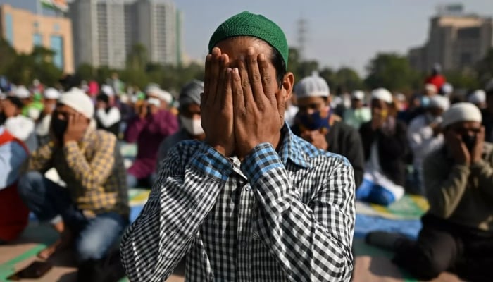 Muslim devotees offer Friday prayers in an open ground in Gurgaon on the outskirts of New Delhi on December 17, 2021. —AFP