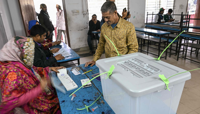 A man waits to receive his ballot paper before voting in Bangladesh´s general election in Dhaka on January 7, 2024. — AFP