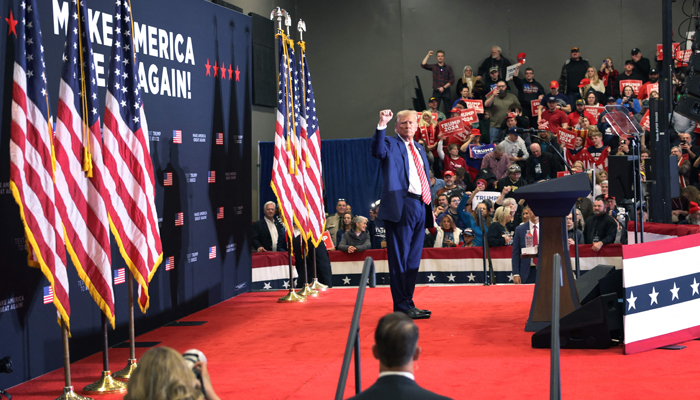 Republican presidential candidate Former President Donald Trump concludes a rally at Clinton High School on January 6, 2024 in Clinton, Iowa. — AFP