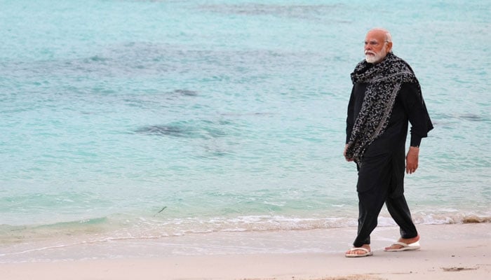 Indian Prime Minister Narendra Modi walks along a beach in Lakshadweep a southern Indian island chain near Kerala. — X/@narendramodi