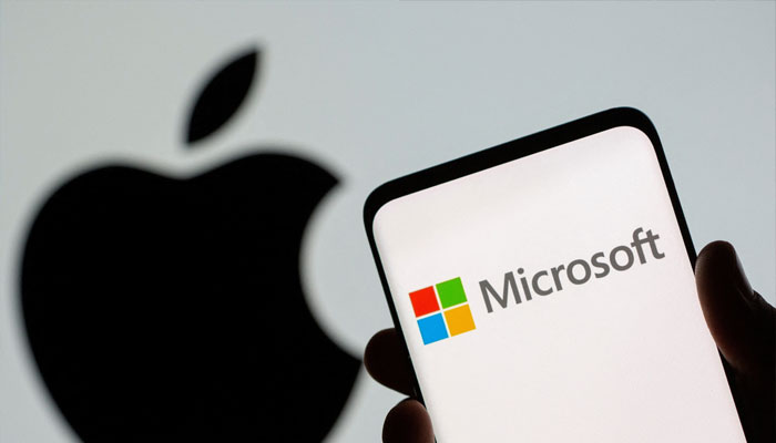 Microsoft logo is seen on the smartphone in front of displayed Apple logo in this illustration taken, July 26, 2021. —Reuters