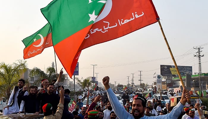Activists of the Pakistan Tehreek-e-Insaf (PTI) take part in an anti-government rally demanding early elections in Peshawar on October 28, 2022. — AFP