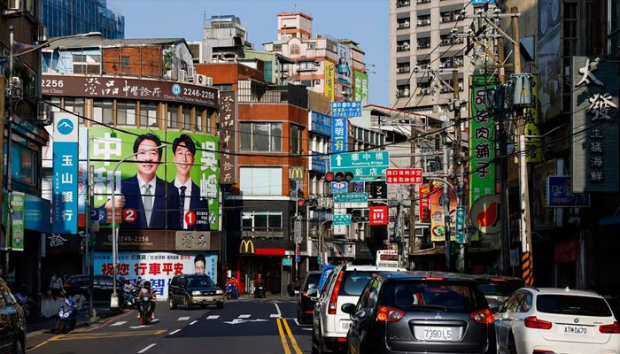 People walk past a campaign advertisement for Lai Ching-te, vice president of Taiwan and presidential candidate of the ruling Democratic Progressive Party (DPP), and Justin Wu, candidate for member of local parliament for the ruling Democratic Progressive Party (DPP), before the elections in Taipei.  Taiwan January 12, 2024. —Reuters