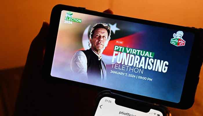 A man shows the social media app of the official site of the Pakistan Tehreek-e-Insaf party (PTI) party on January 7, 2024. — AFP