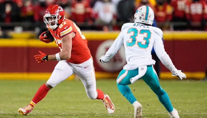 Kansas City Chiefs tight end Travis Kelce (87) runs the ball against Miami Dolphins cornerback Eli Apple (33) during the second half of the 2024 AFC wild card game at GEHA Field at Arrowhead Stadium in  Kansas City, Missouri, US on January 13, 2024. — Reuters