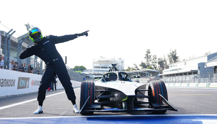 Usain Bolt posing with Formula Es GENBETA car at the Autódromo Hermanos Rodríguez circuit in Mexico on January 13, 2024. — X/@usainbolt