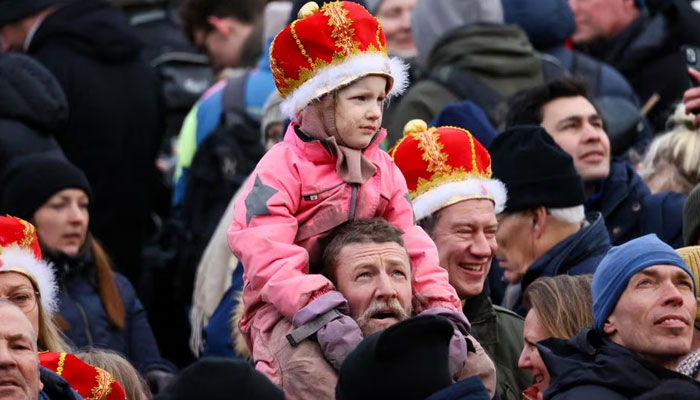 A boy, wearing a crown, watches as people gather, on the day when Danish Queen Margaret abdicates after 52 years on the throne, and her eldest son, Crown Prince Frederick, ascends the throne as King Frederick X, in Copenhagen, Denmark, in January.  September 14, 2024.—Reuters
