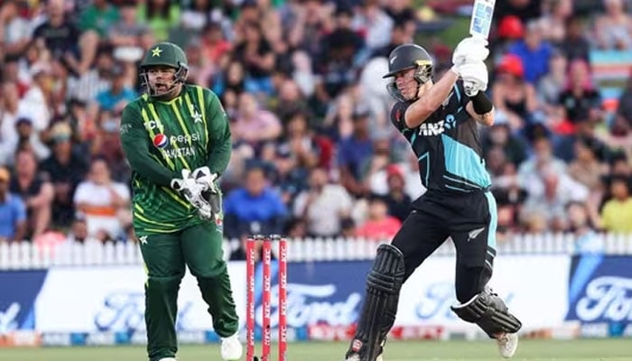 HAMILTON: New Zealand opener Finn Allen plays a shot while being watched by Pakistan wicket-keeper Azam Khan during the second Twenty20 International at Seddon Park on Sunday. —AFP