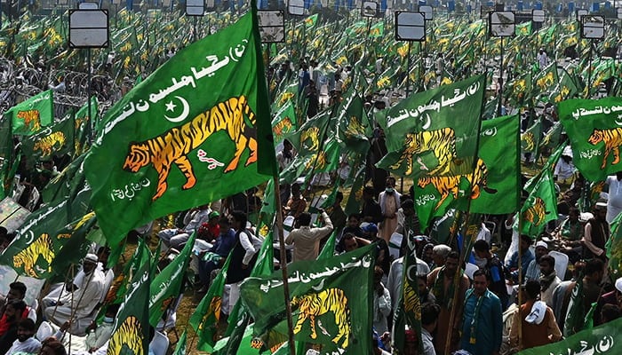 Supporters of former prime minister Nawaz Sharif wait for his arrival for a welcoming rally at a park in Lahore on October 21, 2023. — AFP