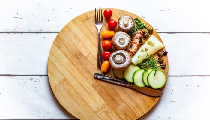 An assortment of foods arranged on a round wooden flat tray with a knife and spoon — Files/AFP