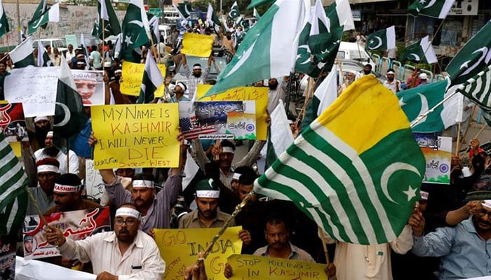 Demonstrators hold signs and chant slogans as they march in solidarity with the people of Kashmir, during a rally in Karachi on August 5, 2019. — Reuters