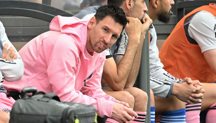 Inter Miami’s Argentine forward Lionel Messi (left) sits on the bench during the friendly football match between Hong Kong XI and US Inter Miami CF in Hong Kong on February 4, 2024. — AFP