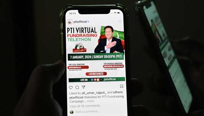 A man checks a social app to monitor the official site of the Pakistan Tehreek-e-Insaf party (PTI) party, as a massive national and global telethon to launch the PTI manifesto and raise campaign funds is launnched, in Islamabad on January 7, 2024. —AFP