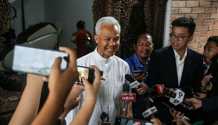 Presidential candidate Ganjar Pranowo speaks to the media before leaving for a polling station during the general election in Semarang, Central Java, on February 14, 2024. –Reuters