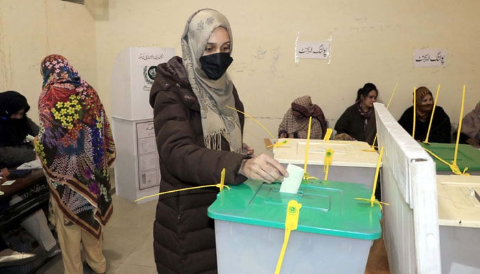A female voter casts her vote at a polling station during general elections 2024, in Lahore on Thursday, February 8, 2024. — PPI
