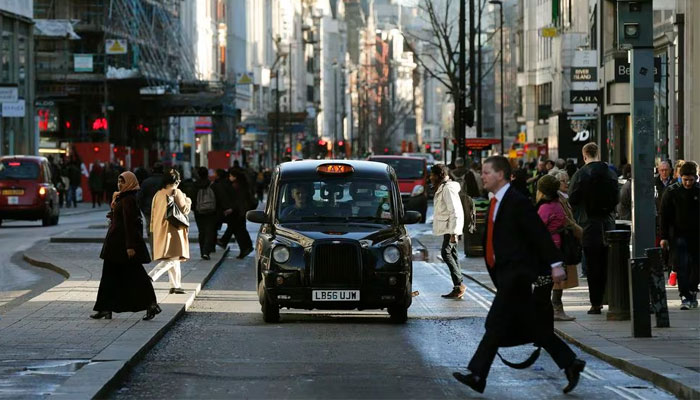 A taxi travels along Oxford Street during a bus strike in London on January 13, 2015. — Reuters