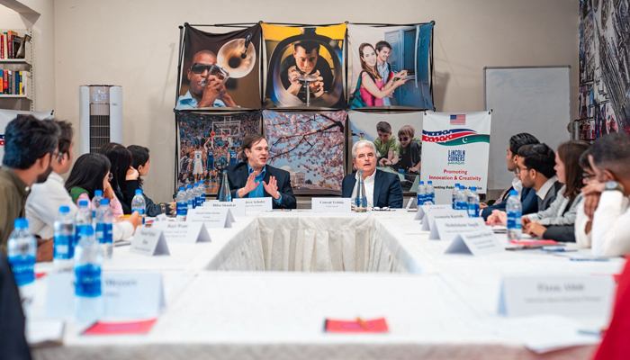 Deputy Chief of Mission of United States Mission in Pakistan Andrew Schofer (centre right) speaks to students in Karachi. — Supplied