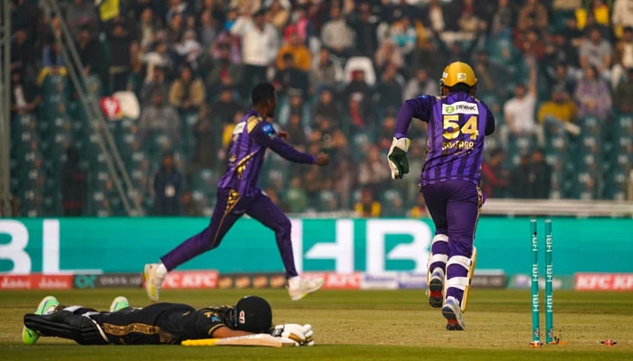 Quetta Gladiators players celebrate as a Peshawar Zalmi batter gets run out during an exciting match at PSL 9 in Lahore on February 18, 2024.