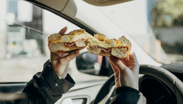 A representational image of a person holding a sandwich. — Unsplash