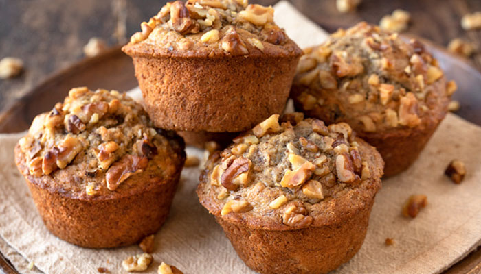 This image shows muffins topped with nuts. — The Cozy Apron