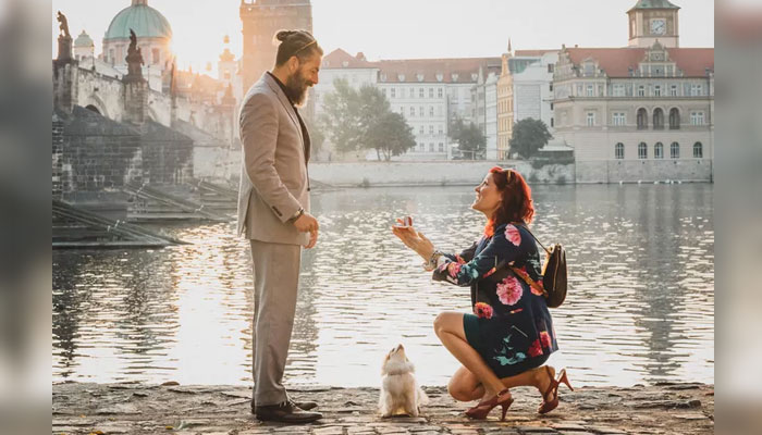 A woman proposes to a man.  — Brides via Flytographer