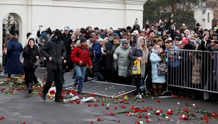 People breaking down barriers gather as they leave an area outside the Soothe My Sorrows church, where a funeral and farewell ceremony was held for Russian opposition politician Alexei Navalny, in Moscow, Russia, on March 1, 2024. – Reuters