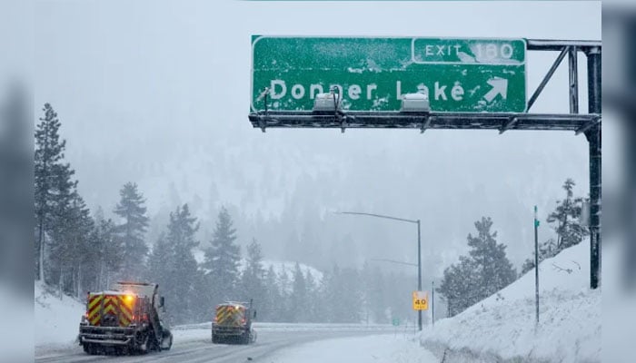 Snowploughs along Interstate 80 near Soda Springs, California in the Sierra Nevada mountains at the start of a powerful winter storm on February 29, 2024. — AFP