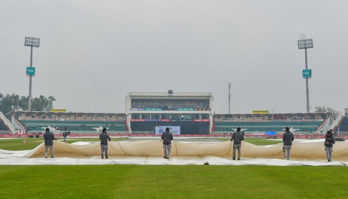 Ground officials are covering the pitch at the Pindi Cricket Stadium on March 2, 2024. — PCB