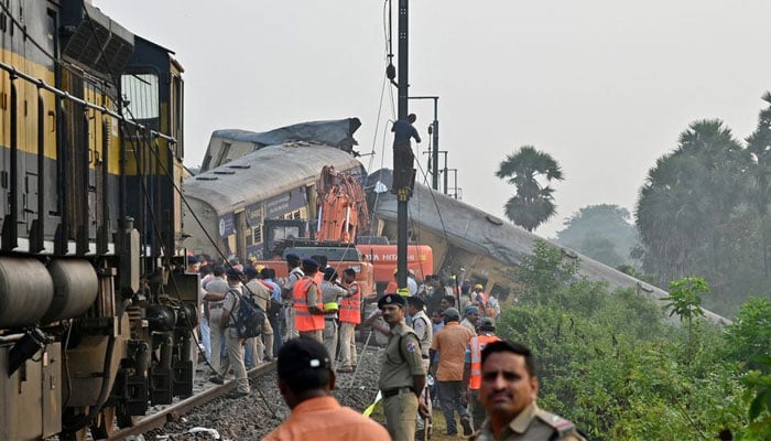 Rescue workers and police officials stand next to damaged coaches following a collision between two passenger trains in Vizianagaram district in the southern Andhra Pradesh state, India, October 30, 2023. — Reuters