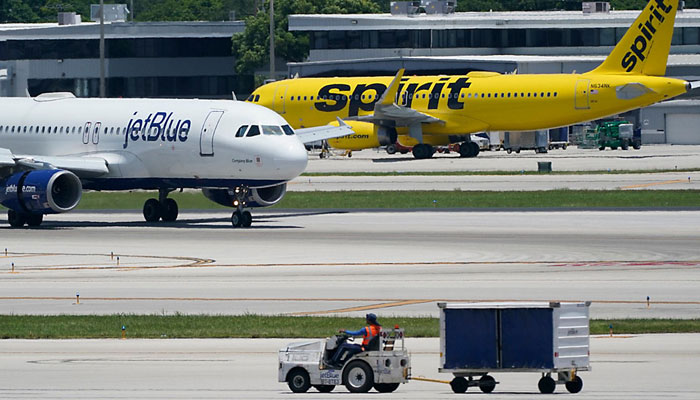 A JetBlue Airways Airbus A320, left, passes a Spirit Airlines Airbus A320 as it taxis on the runway, July 7, 2022, at the Fort Lauderdale-Hollywood International Airport in Fort Lauderdale.—AFP/file