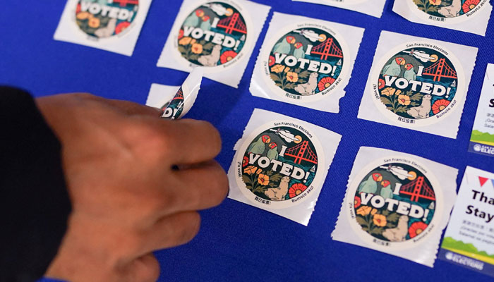 A voter takes a sticker after casting their ballot during early voting, a day ahead of the Super Tuesday primary election, at the San Francisco City Hall voting centre in San Francisco, California, US March 4, 2024. — Reuters