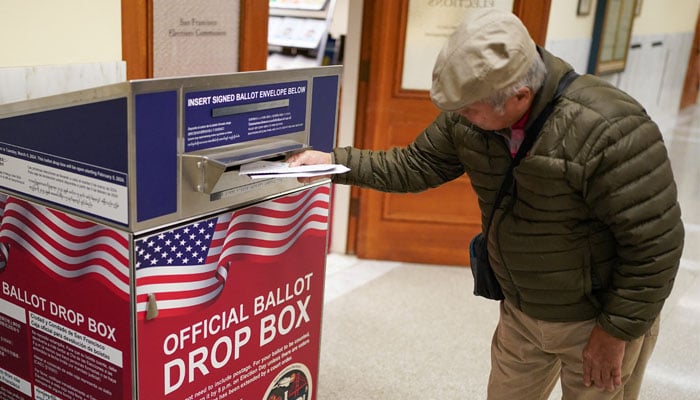 A voter casts her ballot during early voting, a day before the Super Tuesday primary election, at the San Francisco City Hall voting center in San Francisco, California, U.S., March 4, 2024. – Reuters