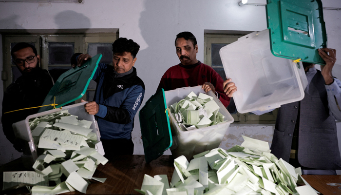 Polling staff empty a ballot box after polls closed at a polling station during the general election, in Lahore, Pakistan, February 8, 2024. — Reuters