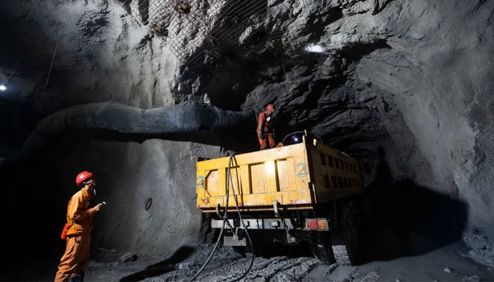 Workers build ventilation ducts at the Zhugongtang lead-zinc mine in Bijie, in China’s southwestern Guizhou province on July 5, 2023. — AFP