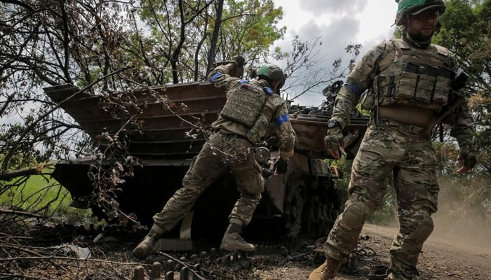 Ukrainian service members check a destroyed Russian BMP-2 infantry fighting vehicle near the front line in the village Storozheve in Donetsk region, Ukraine June 14, 2023. — Reuters