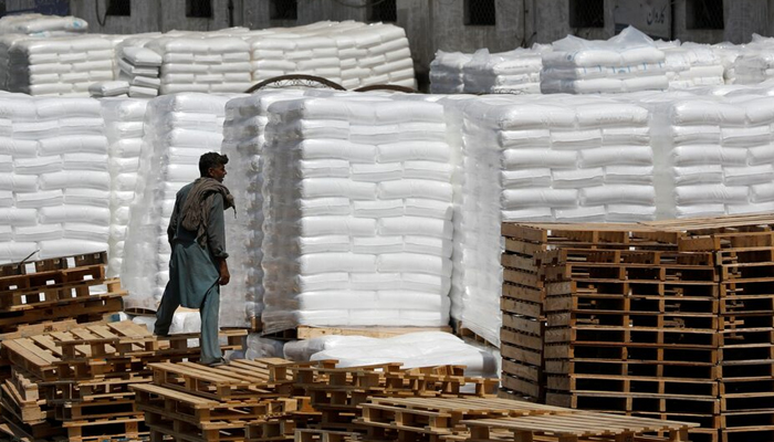 A laborer stands near the cargo supply at a warehouse near the port area in Karachi, Pakistan May 13, 2020. — Reuters