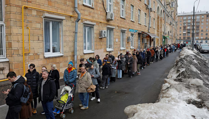 People stand in a line to enter a polling station around noon on the final day of the presidential election in Moscow, Russia, March 17, 2024. — Reuters